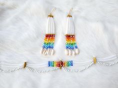 two pairs of white beaded earrings with multicolored beads and dangling ear wires