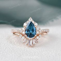 an engagement ring with a blue stone surrounded by diamonds