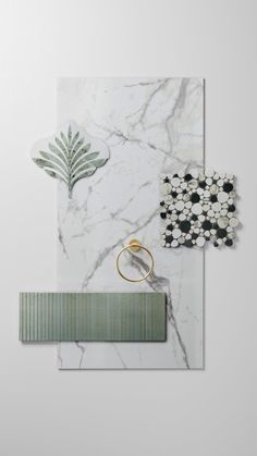 a marble wall with green and white accents on it, along with a gold ring