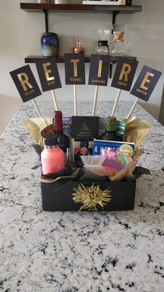 a gift basket is sitting on top of a counter with signs that say retirement and other items