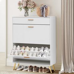 a white shoe rack with several pairs of shoes