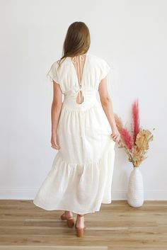 Get ready to turn heads in the stunning Krishna Maxi Dress! Its flowy silhouette and delicate detailing make it the perfect choice for any occasion. With its versatile design, you can easily dress it up or down for a look that exudes confidence and style. Embrace your inner goddess and add this dress to your wardrobe today! Airy Flowy V-neck Dress, Spring Airy Midi Maxi Dress, Spring Flowy Tie Back Maxi Dress, Breezy Flowy Midi Dress, Flowy Tie Back Maxi Dress For Spring, Breezy Midi-length Flowy Dress, Spring Flowy Maxi Dress With Tie Back, Flowy Midi Length Breezy Dress, Flowy Spring Maxi Dress With Tie Back