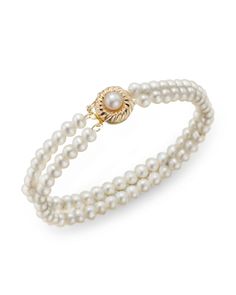 This elegant double-stranded bracelet features cultured freshwater pearls with a 14K yellow gold clasp. Classic Double Strand Pearl Charm Jewelry, Classic Gold Bracelet With Pearl Charm, Classic Multi-strand Jewelry With Pearl Charm, Elegant Double Strand Gold Pearl Bracelet, Classic Gold Pearl Jubilee Bracelet, Elegant Gold Double Strand Pearl Bracelet, Elegant Double Strand Jubilee Bracelet, Classic Pearl Gold Bracelet In Yellow Gold, Elegant Double Strand Pearl Drop Jewelry