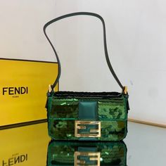 SHOP MORE LUXURY PRODUCTS HERE Description Fendi Mini Baguette 1997 Green Sequinned Bag For Woman 19.5cm/7.5in 8BS049AISLF1H38 Size: 19.5 x 5 x 11 cm / 7.5 x 2 x 4.5 inch Mini 1997 Baguette bag with all-over green metallic sequin embroidery, embellished with an FF clasp.This style is a re-release of the first Fendi Baguette, created in 1997, from which it takes its name and the iconic design to wear under the arm.Featuring a front flap, tone on tone metallic leather details and a magnetic clasp. Fendi Mini Baguette, Mini Baguette, Baguette Bags, Fendi Mini, Louis Vuitton Shirt, Chanel Shirt, Fendi Bag, Embroidery Vintage, Fendi Handbag