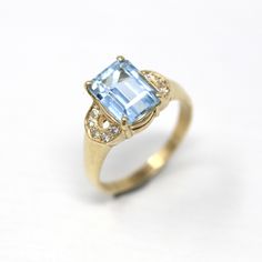 Stunning modern circa 2000's era estate 14k yellow gold genuine aquamarine & diamond ring! This gorgeous ring features an emerald cut 2.82 carat genuine aquamarine. There is a semi-circle of five genuine .01 carat diamonds on each shoulder. A fabulous piece of fine modern jewelry, featuring March's birthstone! *Sale - price reduced from $1,125 USD to $995 USD.  ERA - Circa 2000's - Estate METAL / MATERIAL - 14k yellow gold, genuine emerald cut aquamarine (approx. 2.82 CT), 10 genuine diamonds (a Aquamarine Ring, Blue Gems, Aquamarine Rings, Unisex Jewelry, Natural Aquamarine, Engagement Ring Wedding Band, March Birth Stone, Gold Style, Modern Jewelry