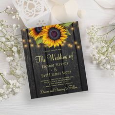 a wedding card with sunflowers and string lights on it next to some flowers