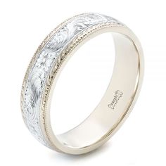 a wedding ring with engraved details on the outside and inside, in white gold or silver