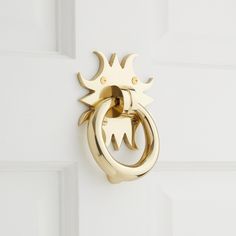 two gold rings are attached to a white door