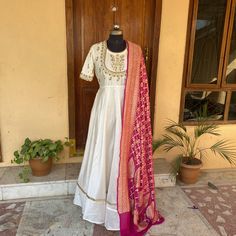 Hand embroidered Anarkali with pure silk banarasi bandhani dupatta / anarkali suit set / anarkali dupatta USA / pure handloom ikkat  dupatta / Indian dresses/ voggish / cream dress with banarasi dupatta / silk mark dupatta set          Looking for a perfect indian dress/anarkali/suit sets that are trendy, unique and easy to carry !! yess, You are at the right place. we carry such versatile pieces of anarkalis and suit sets that really let you stand out in any occassion !!      featuring this bea Ikkat Dupatta With Dress, Bandhani Dupatta Dress, Banarasi Anarkali Suits, Bandhani Dupatta Suits, Suit With Bandhani Dupatta, Banarasi Silk Anarkali Suits, Trendy Anarkali Designs, Silk Dress Indian, White Anarkali Dress