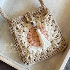 a crocheted bag with a tassel on it