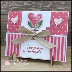 a card with some hearts on it and a ribbon attached to the front of it