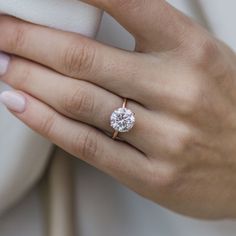 a woman's hand with a diamond ring on it