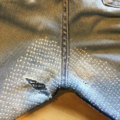 a pair of blue jeans with holes in them