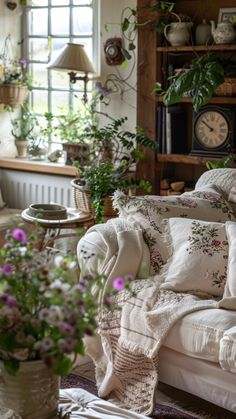 a living room filled with lots of furniture and flowers in vases on the floor