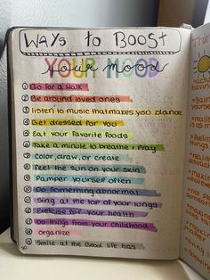 an open book with writing on it that says ways to boost your moon and rainbows