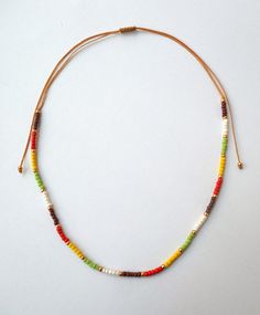 "Beaded Choker, Dainty Choker, Seed Bead Choker, Trendy Jewelry, Bohemian Jewelry, Beach, Summer, Short necklace Girlfriend gift Gift for her Seed bead necklace with seed beads in brown,orange,lime,yellow,gold,ivory and brown waxed string! Light weight around the neck and very comfortable to wear. Choker measures 11.2\"/28.5cm and has a 8.6\"/22cm ending strings that can open up to 28.4\"/72cm. If you need any additional length please convo." Adjustable Beaded Necklace With Letter Beads For Festival, Bohemian Adjustable Necklace With Letter Beads, Bohemian Adjustable Letter Beads Choker, Adjustable Bohemian Letter Beads Choker, Bohemian Yellow Necklace With Letter Beads, Adjustable Beaded Necklace With Wooden And Heishi Beads, Adjustable Wooden Beads Necklace For Summer, Adjustable Beaded Choker With Letter Beads, Bohemian Choker Necklace With Letter Beads