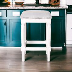 a white stool sitting on top of a kitchen counter