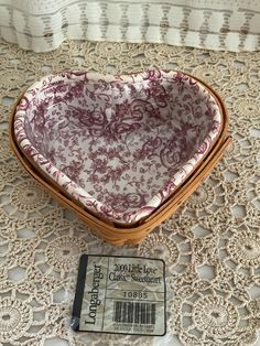 a heart shaped basket sitting on top of a table