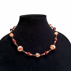 This 19 1/2 inch single strand necklace features a series of marbled red, white, clear, orange and gold foil Murano glass round beads in two sizes. The marbled beads are alternated with large dark red rondelle crystals.  The remainder is strung with dark reddish-brown seed beads, bright  copper beads and light peach crystals to continue the warm color palette. Completed with a antiqued copper toggle clasp. Necklace will be packaged in a jewelry gift box.  All items are mailed via USPS. Free US s Red Glass Beaded Necklaces With Round Beads, Red Glass Necklace With Round Beads, Hand-strung Red Carnelian Beaded Necklaces, Brown Carnelian Large Beaded Necklace, Artisan Red Carnelian Beaded Necklace, Kazuri Beads, Lampwork Bead Earrings, Murano Glass Earrings, Mermaid Glass