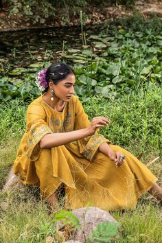 Yellow kota chanderi kurta with dori thread floral embroidery. Paired with pant.
Component: 2
Pattern: Embroidered
Type Of Work: Floral Motifs
Neckline: Round
Sleeve Type: Three Quarter
Fabric: Kurta: Kota Chanderi, Pant: Cotton
Color: Yellow
Other Details: 
Frill detail on sleeves
Front gathers on kurta
Note: The outfit worn by the other model on the back is not for sale
Occasion: Mehendi and Haldi - Aza Fashions Bohemian Straight Kurta Set With Floral Embroidery, Bohemian Set With Straight Kurta And Floral Embroidery, Bohemian Sets With Straight Kurta And Floral Embroidery, Bohemian Sets With Floral Embroidery On Straight Kurta, Designer Kurta With Floral Embroidery In Mulmul, Designer Wear Kurta With Floral Embroidery In Mulmul, Designer Mulmul Kurta With Floral Embroidery, Straight Kurta With Floral Embroidery In Mulmul, Designer Floral Embroidered Mulmul Kurta