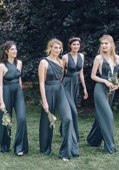 four beautiful women in long dresses standing together