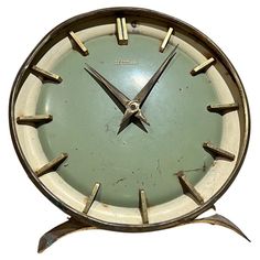 an old clock with metal hands and numbers on the face is shown against a white background