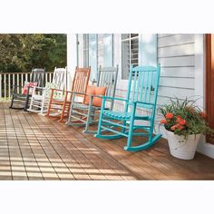 four wooden rocking chairs sitting on the front porch