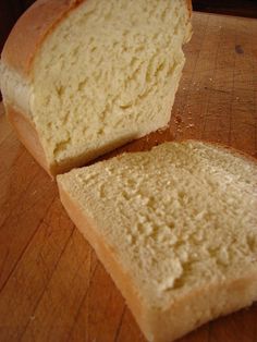 a loaf of bread sitting on top of a table next to some slices of bread