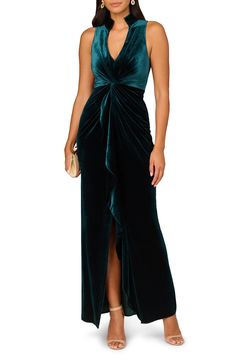 Fashioned from sumptuous velvet, this tastefully twisted tulip gown stuns in a sleeveless silhouette with an unexpected stand collar. 62" length Hidden back-zip closure Deep V-neck; stand collar Sleeveless Front slit Lined 90% polyester, 10% elastane Dry clean Imported Black Gowns, High Low Gown, High Low Midi Dress, Evening Dress Collection, Green Velvet Dress, Gown Black, Velvet Gown, Adrianna Papell Dresses, Gowns Online