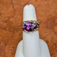 Estate/ vintage 14KT yellow gold checkerboard, oval, genuine, purple amethyst, gypsy-set multi gemstones, and diamond ring. Wide, cigar band style with vibrant colors. Size 6 Can be resized by us for a fee, or your local jeweler Ring weight: 4.90 DWT (4) Diamonds on prongs 13.8mm x 10mm center, oval, checkerboard faceted amethyst stone set in yellow gold. Gypsy-set, multi gemstones including citrine, tourmalines, etc. Stamped 14K and Hallmarked B & M Collectible Oval Rings With Gemstone Accents, Oval Purple Amethyst Ring With Gemstone Accents, Heirloom Purple Rings With Gemstone Accents, Oval Multi-stone Gemstones For Collectors, Heirloom Oval Amethyst Ring With Accent Stones, Heirloom Multi-stone Purple Amethyst Ring, Oval Amethyst Ring With Gemstone Accents, Oval Multi-stone Amethyst Gemstones, Oval Purple Jewelry With Gemstone Accents