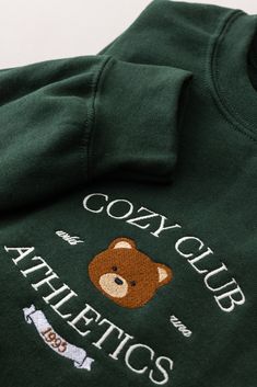 EXCLUSIVE Cozy Club Athletic Crewneck Sweater with embroidered design. Forest green crewneck sweatshirt with fleece lining. Unisex sizing. Size small - 40" bust Size medium - 44" bustSize large - 48" bust Size xl - 52" bust *Not eligible for discount Green Embroidered Tops For Winter, Winter Crew Sweatshirt With Embroidered Logo, Crew Sweatshirt With Embroidered Logo For Winter, Winter Fleece Sweatshirt With Embroidered Logo, Cozy Long Sleeve Sweatshirt With Embroidered Logo, Winter Sweater With Embroidered Graphics, Green Long Sleeve Sweatshirt With Embroidered Graphics, Casual Green Sweater With Embroidered Graphics, Winter Long Sleeve Sweater With Embroidered Graphics