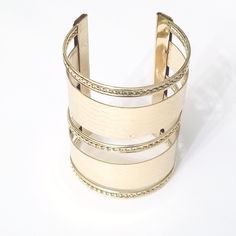 Gold cuff bracelet that features braid and crocodile detailing in the design. Elevate your monochromatic outfits with this simple addition. Material: Metal Style: Cuff Bracelet Color: Gold Elegant Adjustable Band Cuff Bracelet, Chic Metal Bangle Cuff Bracelet, Gold Leather Cuff Bracelet, Chic Metal Cuff Bangle Bracelet, Trendy Adjustable Jubilee Bracelet Bangle, Chic Adjustable Double Band Bracelet, Adjustable Gold Leather Cuff Bracelet, Modern Cuff Bracelet Bangle As Fashion Accessory, Trendy Metal Cuff Bracelet