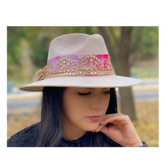 Rosa Palo Artisan Hat - Beautiful handmade hat - This beautiful rosa palo hat is the perfect statement piece for your #OOTD, for any occasion, any season! It features a gorgeous tie dye band with gold details and pom pom details on thhe back. This is the perfect hat for a girl who loves to stand out. Details & Fit - One size fits all Gold Wide Brim Bohemian Fedora, Adjustable Gold Fedora For Festivals, Bohemian Gold Hat With Short Brim, Gold Bohemian Brimmed Hat, Bohemian Adjustable Fedora For Parties, Bohemian Hat Bands For Party, Bohemian Hat Bands For Kentucky Derby Party, Bohemian Adjustable Hat Bands For Party, Bohemian Adjustable Hat Bands For Parties