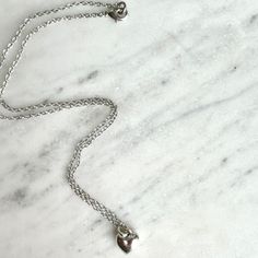 Freya meaning: For a noblewoman A classic sterling plated chain and solid heart charm with a nice weight to the touch. Measures: 16" Dainty Small Charm Necklace For Everyday, Classic Charm Necklace With Delicate Chain For Everyday, Elegant Everyday Charm Necklace With Rolo Chain, Classic Heart Pendant Jewelry With Adjustable Chain, Classic Charm Necklaces With Delicate Chain For Gift, Delicate Rolo Chain Necklace For Everyday, Classic Sterling Silver Heart Necklace, Classic Silver Necklace With Heart Charm, Classic Heart-shaped Sterling Silver Necklace