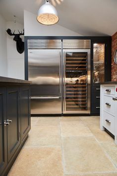 a modern kitchen with stainless steel appliances and cabinets