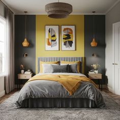 a bedroom with yellow walls and gray bedding, two paintings on the wall above the bed