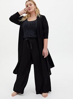 A Super Soft Plush lounge pant with a drawstring waist will have you lounging like a queen.   Matching style(s): Search 14335398, 14335365 Super Soft Plush knit fabric. Stretch drawstring waist. Front pockets. Wide leg. CONTENT + CARE Rayon/polyester/spandex. Wash cold; dry flat. Imported plus size sleepwear. SIZE + FIT Model is 5’10”, size 1. 28. 5” inseam. The best plus size women's super soft plush black wide leg drawstring sleep pant bottoms in deep black made of super soft plush. Lesbian Formal Outfits Plus Size, Plus Size Pajamas For Women, Wide Leg Lounge Pants, Plus Size Sleepwear, Plus Size Pajamas, Pajamas Comfy, Sleep Pants, Fitted Wedding Dress, Matches Fashion