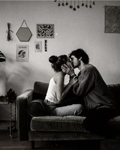 black and white photograph of two people sitting on a couch