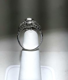 A wonderful Victorian band with great filigree detail. The center stone measures out at .80 ct and has a clarity of SI1 and G color. There is a small natural crystal on the girdle. On either side are 2 @.05ct diamonds set in diamond shape gold. The band weighs 2.5 grams and is is excellent condition. It measures 8.5mm across the top. Classic Formal Jewelry With Diamond Accents, Asscher Cut Diamond Wedding Ring With Diamond Accents, Asscher Cut Diamond Wedding Ring With Accents, Antique Diamond Ring With Vvs Clarity, Emerald Cut Diamond Accented Wedding Jewelry, Formal White Gold Filigree Jewelry, Emerald Cut Diamond Jewelry For Wedding, Formal Round Cut Jewelry With Diamond Accents, Emerald Cut Diamond Wedding Jewelry With Accents