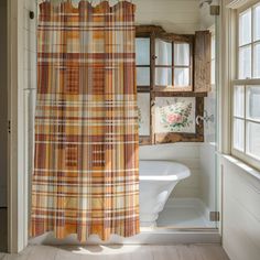 a bath room with a tub and a shower curtain