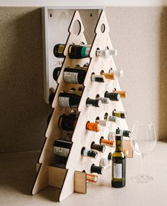 a christmas tree shaped wine rack with bottles