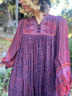 "Vintage 1970s Indian cotton floral print dress with an attached slip, in a beautiful mix of purple, brick red and navy blue by Starina. This dress is so feminine and romantic. Perfect for the holidays! Best Fit: s/m Bust: 30-36\" Waist: open Hip: open Length: 48\" Condition: excellent" Purple Bohemian Maxi Dress For Fall, Bohemian Purple Maxi Dress For Fall, Purple Bohemian Dress With Floral Print, Vintage Boho Floral Print Maxi Dress, Vintage Boho Floral Maxi Dress, Vintage Boho Maxi Dress With Floral Print, Vintage Long Sleeve Floral Print Boho Dress, Vintage Long Sleeve Boho Dress With Floral Print, Vintage Floral Print Boho Festival Dress