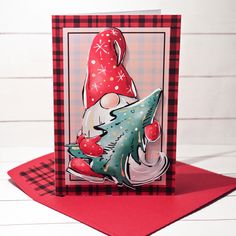 a card with a gnome holding a christmas tree