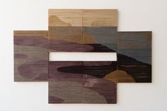 four pieces of wood are arranged in the shape of an e, with different colors and shapes