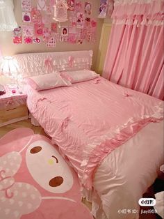 a bedroom with pink bedding and decorations on the walls, along with a teddy bear rug