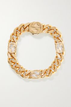 Gucci's bracelet has chunky gourmette - French for the word 'curb' - links, some of which are shaped in the signature 'GG' emblem. It's made from gold-tone brass and lays comfortably flat against your wrist. Gucci Gold Jubilee Bracelet Jewelry, Gucci Gold Jubilee Bracelet, Luxury Gucci Chain Bracelet, Luxury Gucci Chain Bracelet As Gift, Elegant Gucci Chain Bracelet For Gift, Gucci Luxury Link Jewelry, Classic Gold Gucci Bracelets, Classic Gold Gucci Bracelet, Classic Gucci Chain Jewelry