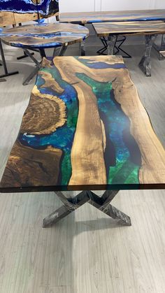 the table is made out of wood and has blue, green, and yellow paint on it