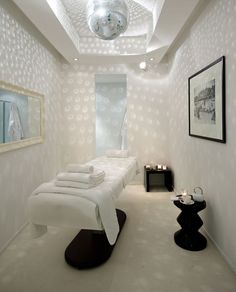 a bathroom with white walls and carpeted flooring next to a mirror on the wall