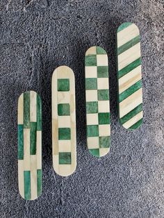 four green and white skateboards laying on the ground