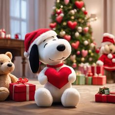 a stuffed dog with a heart sitting next to a teddy bear in front of a christmas tree